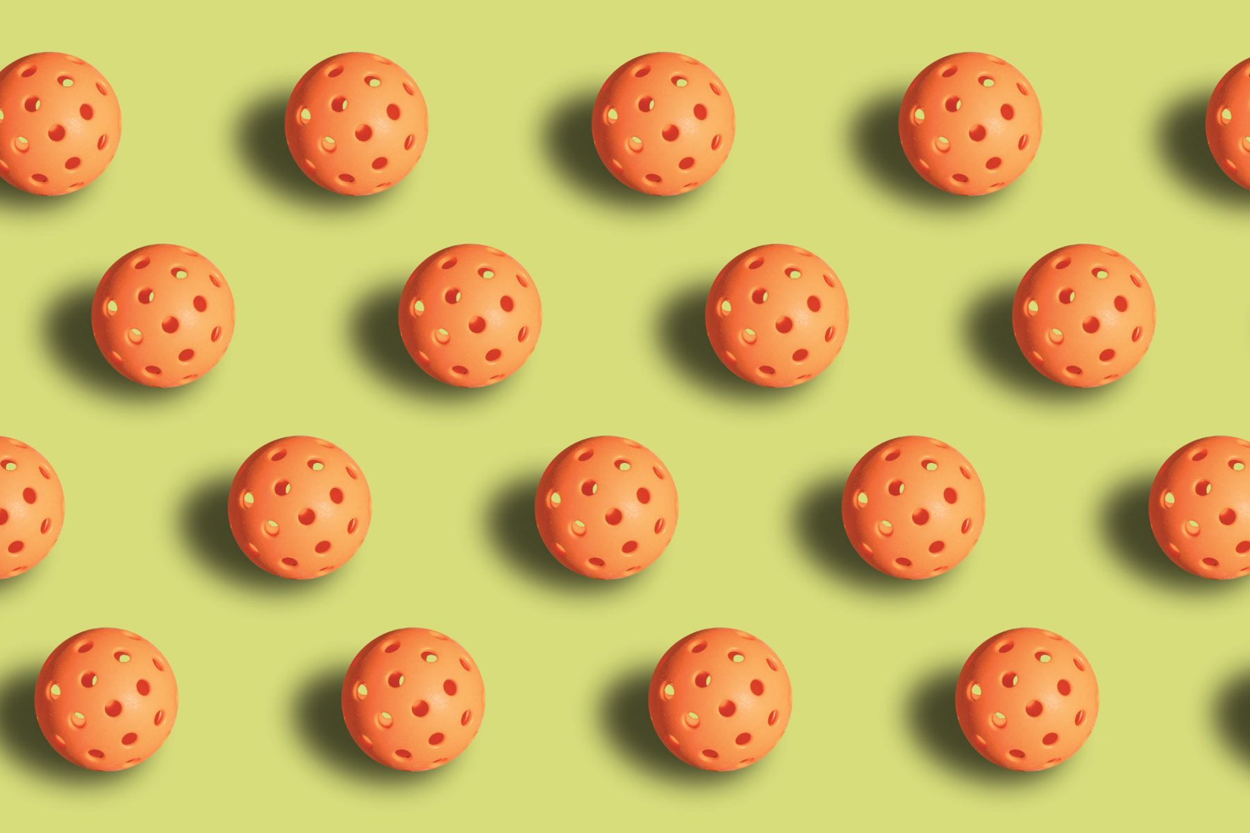 Bright lime green background with a repeating pattern of orange pickleballs.